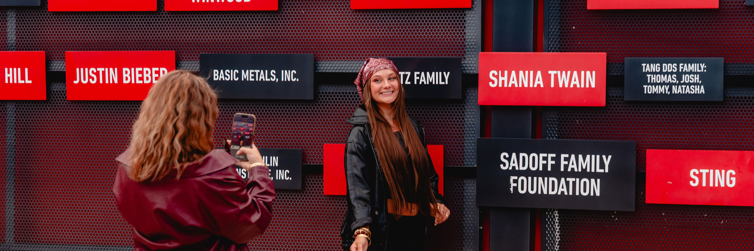 Fans posing with the Wall of Fame